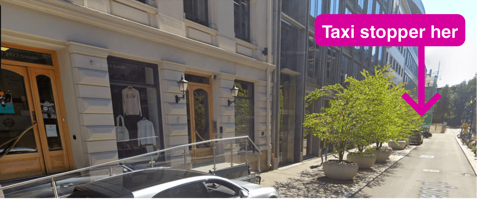 Angled view of the entrance to Samisk Hus, with a pink arrow indicating where taxis can stop.